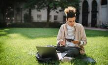 Man on grass with laptop