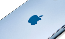 A close up of the logo on an Apple iPhone 12 Pro with a Pacific Blue finish.