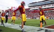 Jayden Maiava #14 of the USC Trojans celebrates with Ja'Kobi Lane #8 of the USC Trojans during the second half against Notre Dame Fighting Irish at United Airlines Field at the Los Angeles Memorial Coliseum on November 30, 2024 in Los Angeles, California.