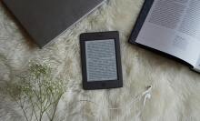 Kindle on fluffy blanket