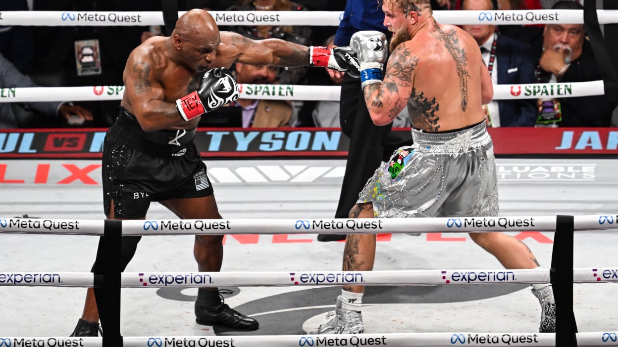 Mike Tyson (in black short) and Jake Paul (in silver short) exchange punches during their heavyweight world titles of the Premiere Boxing Championship