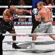 Mike Tyson (in black short) and Jake Paul (in silver short) exchange punches during their heavyweight world titles of the Premiere Boxing Championship