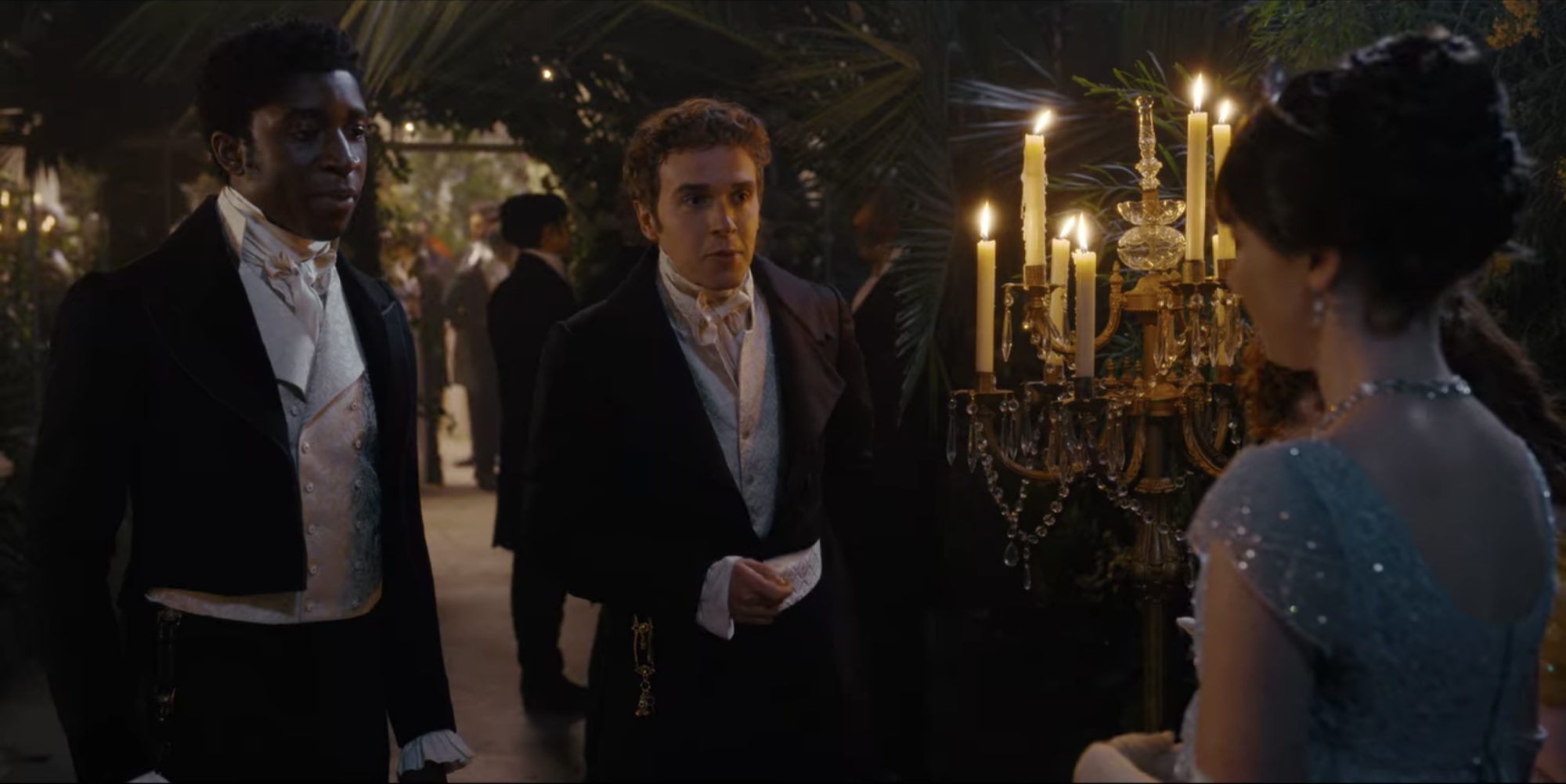 Two young men in Regency formalwear approach a young woman, asking for a dance; still from "Bridgerton."