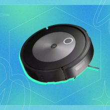 Roomba j7 robot vacuum positioned on blue and green backdrop