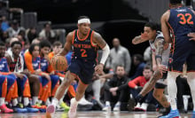 Miles McBride #2 of the New York Knicks dribbles the ball around Kyle Kuzma #33 of the Washington Wizards during the first half at Capital One Arena on December 30, 2024 in Washington, DC. 