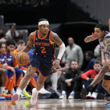 Miles McBride #2 of the New York Knicks dribbles the ball around Kyle Kuzma #33 of the Washington Wizards during the first half at Capital One Arena on December 30, 2024 in Washington, DC. 