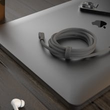 Flexi Pro charging cable on laptop with airpods