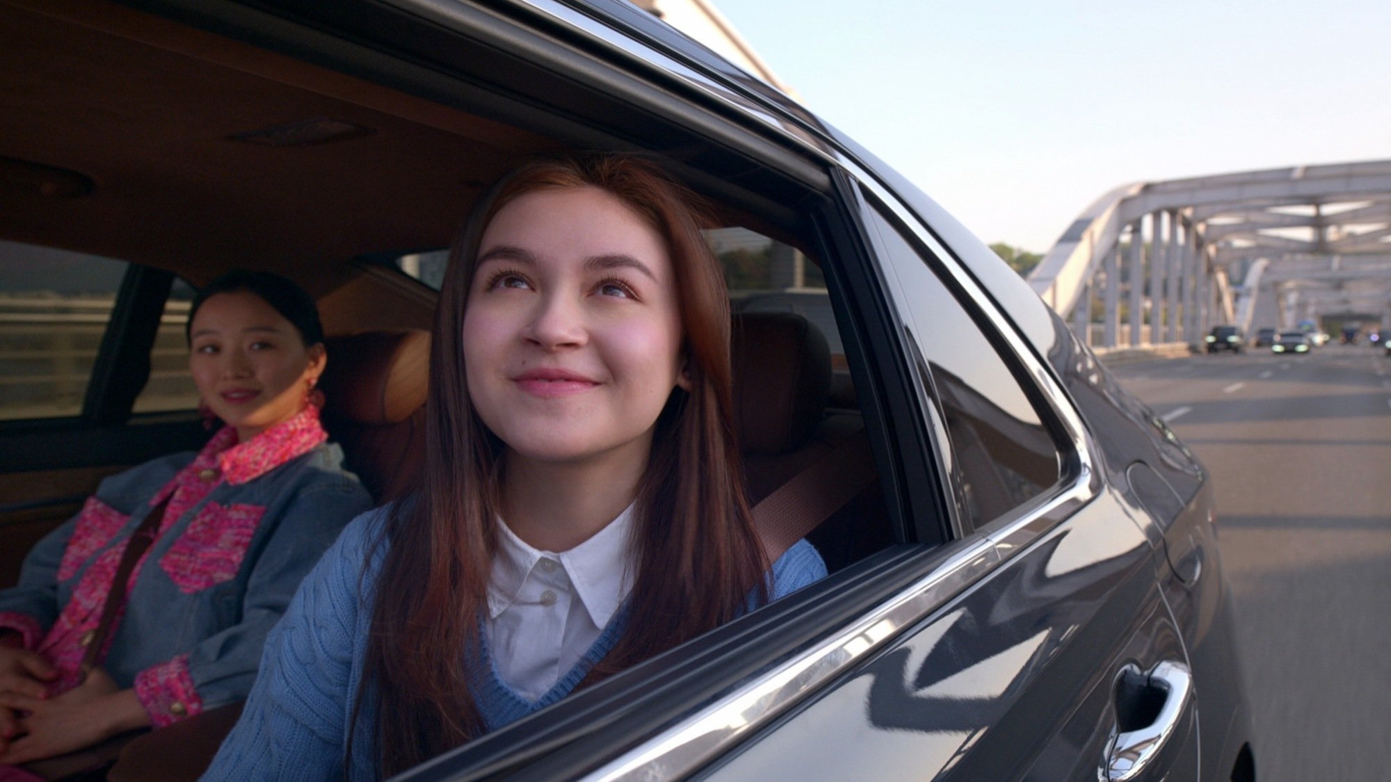 Two girls ride in a car