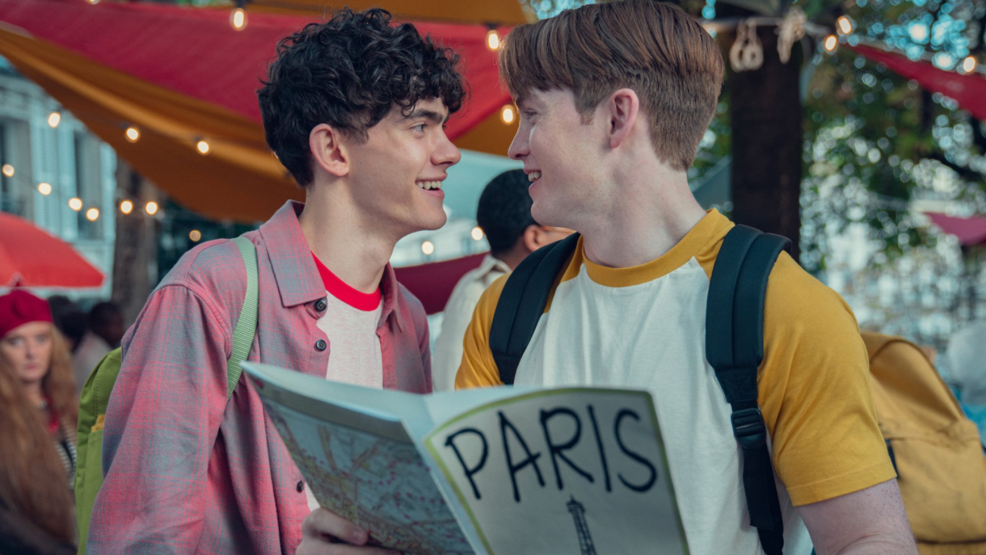 Two teen boys lock eyes. 