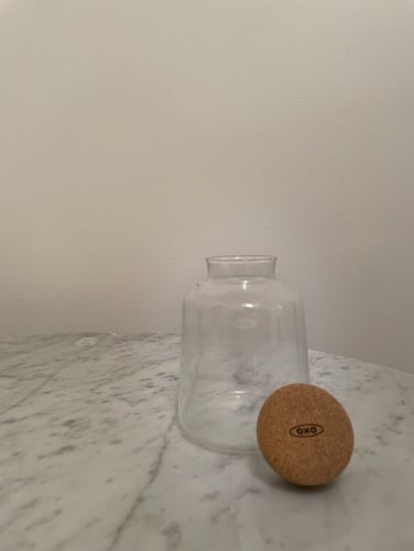 glass carafe with cork stopper next to it