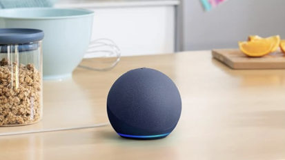 The 5th gen Echo Dot standing on a kitchen counter 