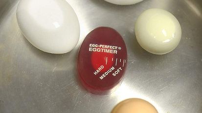 eggs in water with red egg-shaped timer