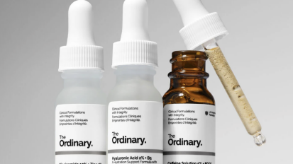 Three of The Ordinary's skincare products in mini bottles artfully placed in a line