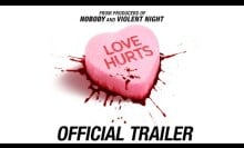 A pink candy heart that says "Love Hurts."