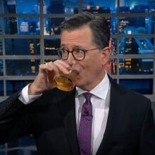 Stephen Colbert drinking bourbon on The Late Show with Stephen Colbert.