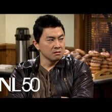 asian man in leather jacket and brown button up shirt