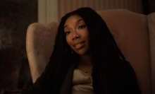 Brandy sits in a chair in the film "The Front Room."