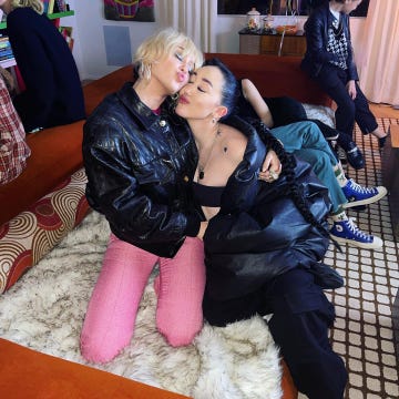 a woman sitting on a woman's lap