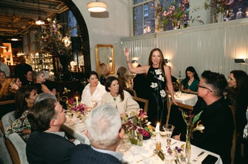 a group of people sitting at a table with candles