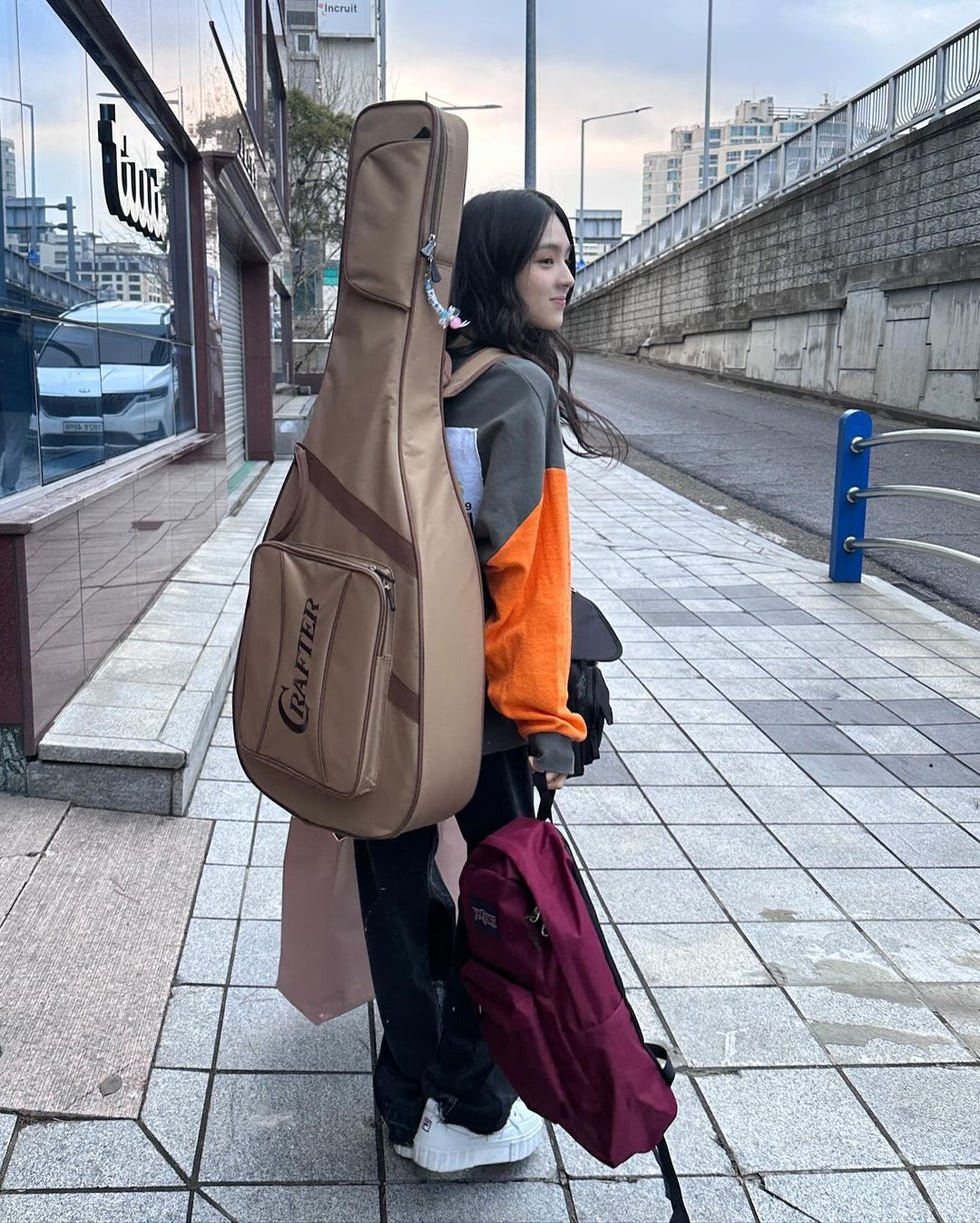 a person holding a large brown bag