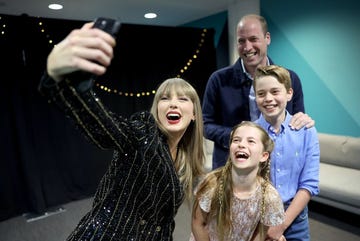 taylor swift posing with prince william, princess charlotte, and prince george during the london eras tour show