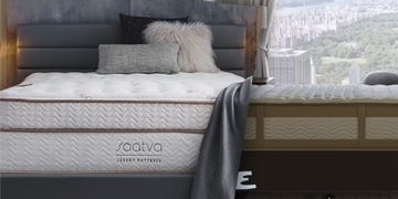 comparison of luxury mattresses with a city skyline view in the background