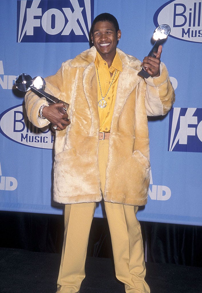 best 90s fashion trends, man, usher, wearing a yellow fur coat during awards ceremony