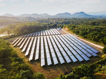 aerial view of the solar power plant on the mountain at sunset