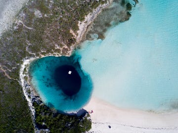 aerial vision, drone capture of the tropical white beaches of long island the bahamas