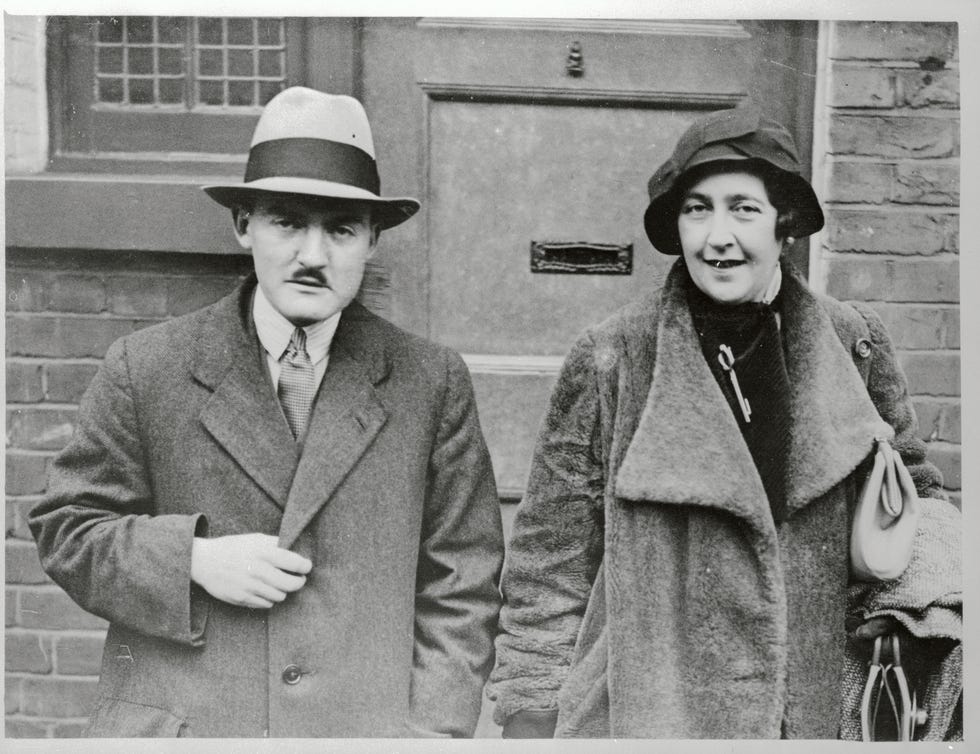 max mallowan and agatha christie stand next to each other and smile while looking ahead