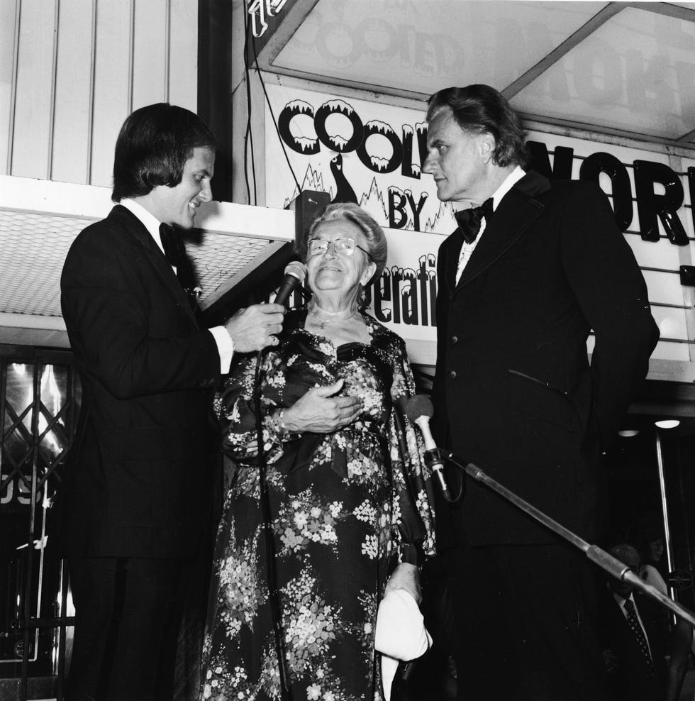 corrie ten boom giving an interview with a reporter holding a microphone for her