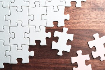 assembling jigsaw puzzle pieces abstract background