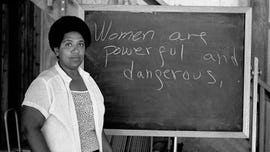 audre lorde lectures students at the atlantic center for the arts in new smyrna beach, florida next to a chalkboard that says women are powerful and dangerous