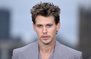 austin butler wearing a gray suit and looking ahead for a photograph