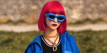a person with red hair and sunglasses