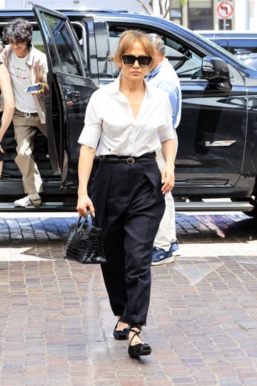 jennifer lopez on june 29, 2024 in los angeles wearing a white shirt and pinstripe pants by christian dior