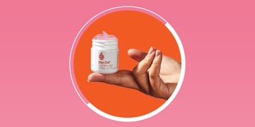 a persons hand holds a small white container labeled bio oil dry skin ge