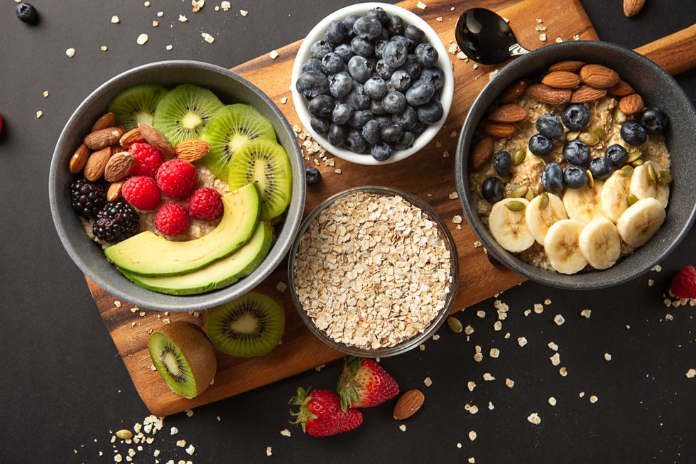 bowls of oatmeal with mixed fruits topping