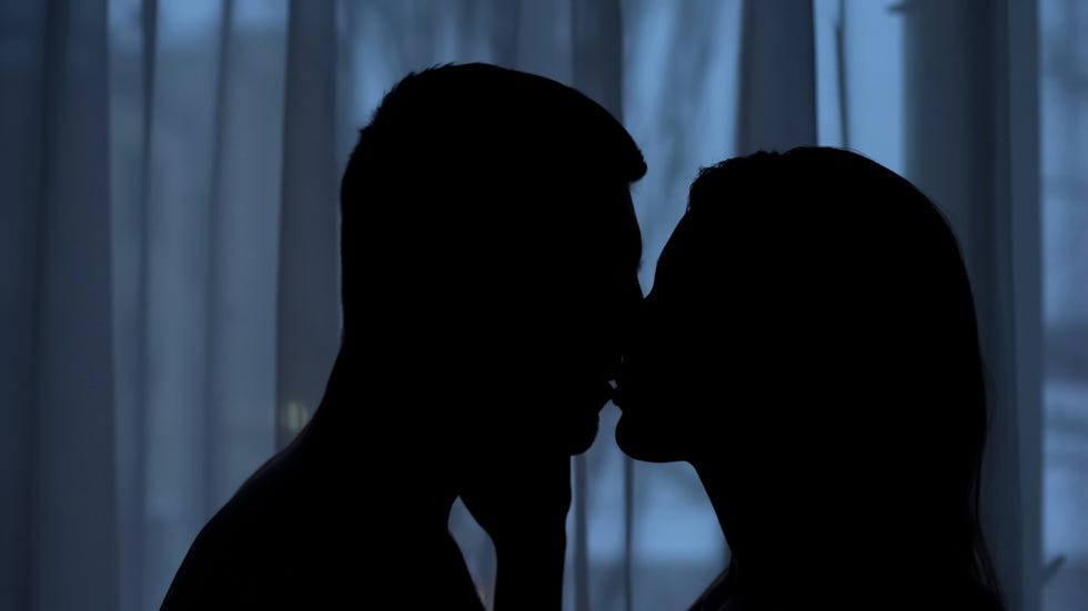 boyfriend and girlfriend silhouettes kissing in dark, affection, love feeling