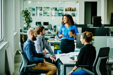 businesswoman leading meeting with colleagues