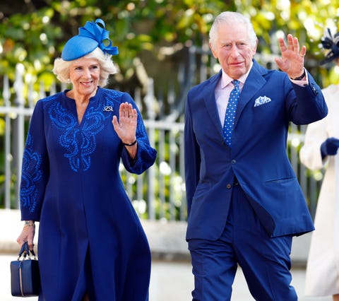 camilla, queen consort, and king charles iii wearing blue outfits and waiving off camera