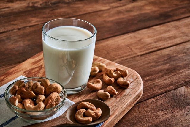 cashew milk on rustic wooden table with copy space