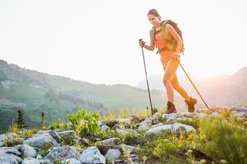 caucasian woman hiking on rocky trail