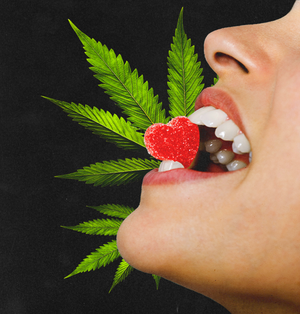 a woman holding a heart shaped gummy between her teeth