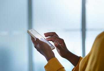 close up of businesswomans hands holding phone