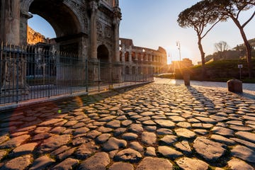 coliseum and arch of constantine at sunrise, rome, italy