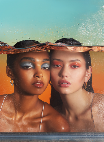 2 girls behind tank of water