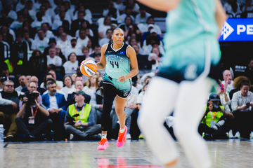 A basketball player dribbling a ball during a game