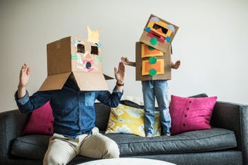 father and daughter wearing robot costumes at home