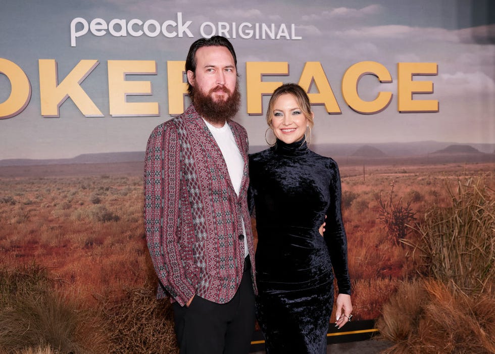 kate hudson and her fiance danny fujikawa embracing and smiling for a photo